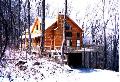Side of cabin on snowy day